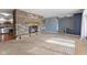 Cozy living room with a stone fireplace and a seamless flow to the adjacent living spaces at 2016 Colt Rd, Indianapolis, IN 46227