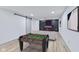 Finished basement with recreational space, modern design, foosball table, tv, and comfortable seating at 218 W 31St St, Indianapolis, IN 46208