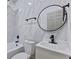 Elegant bathroom featuring marble-style tiles and black matte fixtures at 218 W 31St St, Indianapolis, IN 46208