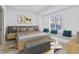 Comfortable bedroom boasts a cozy window seat, neutral decor, and ample natural light at 218 W 31St St, Indianapolis, IN 46208