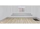 Bright, airy room with light wood floors and a large window overlooking a brick building at 218 W 31St St, Indianapolis, IN 46208