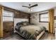 Tranquil bedroom with a rustic wood accent wall, comfortable bed, and natural light from two windows at 362 1400 N, Summitville, IN 46070