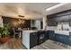 Stylish kitchen featuring black cabinetry, an island with a cooktop, and a dining area at 362 1400 N, Summitville, IN 46070