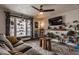 Bright living room with a comfortable sofa, large windows and lots of thriving plants at 362 1400 N, Summitville, IN 46070
