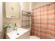Modern bathroom features a white sink, decorative mirror, and stylish shower curtain at 403 S Ohio St, Sheridan, IN 46069