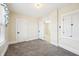 A bright bedroom with fresh neutral paint, plush carpet, and natural light offers a serene retreat at 403 S Ohio St, Sheridan, IN 46069