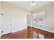 Sunlit bedroom features hardwood floors, a ceiling fan, and a window with sheer lace curtains at 403 S Ohio St, Sheridan, IN 46069