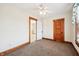 A quaint bedroom with plush carpet, light paint, and natural wood trim creates a cozy haven at 403 S Ohio St, Sheridan, IN 46069