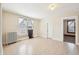 Neutral bedroom with large window, vintage radiator, and adjacent room entrance at 403 S Ohio St, Sheridan, IN 46069