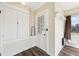 Inviting entryway featuring wood-look floors, coat rack, and a charming door with lace curtain at 403 S Ohio St, Sheridan, IN 46069