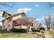 Attractive home boasts a covered porch, red trim, and a neatly landscaped front yard at 403 S Ohio St, Sheridan, IN 46069