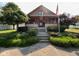 Charming home featuring a covered porch, red columns, and a well-maintained front yard with mature trees and landscaping at 403 S Ohio St, Sheridan, IN 46069