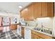 Eat-in kitchen featuring wooden cabinets, modern appliances, and stainless steel sink at 403 S Ohio St, Sheridan, IN 46069