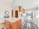 Eat-in kitchen featuring a breakfast bar, wooden cabinets, and tile flooring at 403 S Ohio St, Sheridan, IN 46069