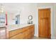 Eat-in kitchen featuring a breakfast bar, wooden cabinets, and wood door at 403 S Ohio St, Sheridan, IN 46069