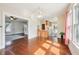 Bright, open living room with hardwood floors, a bar, and seamless flow to other rooms at 403 S Ohio St, Sheridan, IN 46069