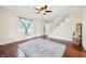 Spacious living room with hardwood floors, a ceiling fan, and staircase at 403 S Ohio St, Sheridan, IN 46069