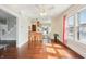 Bright living room featuring hardwood floors, ceiling fan, and breakfast bar to the kitchen at 403 S Ohio St, Sheridan, IN 46069