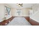 Open living room with hardwood floors, a ceiling fan, and staircase access at 403 S Ohio St, Sheridan, IN 46069