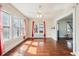 Bright living room featuring hardwood floors, large windows and an archway to another living space at 403 S Ohio St, Sheridan, IN 46069