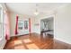 Bright living room featuring hardwood floors, ceiling fan, and an archway to another living space at 403 S Ohio St, Sheridan, IN 46069