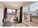 Bright sunroom with wood floors, large windows, sliding glass doors to a wooden outdoor deck at 403 S Ohio St, Sheridan, IN 46069