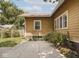 Backyard patio area with lush green landscaping and yellow siding at 4220 Sunset Ave, Indianapolis, IN 46208