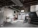 Unfinished basement with laundry area and stairs leading to the upper level at 4220 Sunset Ave, Indianapolis, IN 46208