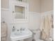 Charming bathroom with beadboard walls, a pedestal sink, and classic fixtures at 4220 Sunset Ave, Indianapolis, IN 46208