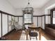 Light-filled dining room with hardwood floors, wood trim, and a modern chandelier at 4220 Sunset Ave, Indianapolis, IN 46208