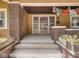 Inviting front porch with brick pillars, flower boxes, and decorative prayer flags hanging overhead at 4220 Sunset Ave, Indianapolis, IN 46208