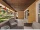 Comfortable seating on the covered front porch with wood ceiling and brick accents at 4220 Sunset Ave, Indianapolis, IN 46208