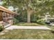 Landscaped front yard with mature tree partially obstructing view of the house with inviting walkway at 4220 Sunset Ave, Indianapolis, IN 46208