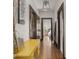 Hallway with hardwood floors, view of bedroom, and a yellow desk on the side at 4220 Sunset Ave, Indianapolis, IN 46208