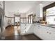 Bright kitchen flows into the dining area with white cabinets and granite countertops at 4220 Sunset Ave, Indianapolis, IN 46208