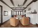 Bright living room features hardwood floors, exposed beam ceiling, fireplace, and classic architecture at 4220 Sunset Ave, Indianapolis, IN 46208