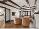 Bright living room features hardwood floors, exposed beam ceiling, fireplace, and classic architecture at 4220 Sunset Ave, Indianapolis, IN 46208