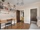 Bright living room with hardwood floors, a gray sofa, and shelving for books at 4220 Sunset Ave, Indianapolis, IN 46208