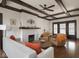 Bright living room features hardwood floors, exposed beam ceiling, and a cozy brick fireplace at 4220 Sunset Ave, Indianapolis, IN 46208