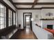 Cozy living room with wood-beamed ceiling, hardwood floors, and a decorative fireplace at 4220 Sunset Ave, Indianapolis, IN 46208