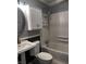 Bathroom with walk-in shower, white pedestal sink, toilet, mirror, and white cabinets at 4916 Ingleside Ln, Indianapolis, IN 46227