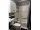Bathroom with white subway tile surround, shower head, white cabinets and gray beadboard at 4916 Ingleside Ln, Indianapolis, IN 46227