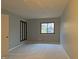 Spacious bedroom features neutral carpet, a large window, and paneled accent at 5746 Overcrest Dr, Indianapolis, IN 46237