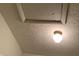 Close-up of a white-painted textured ceiling with a light fixture at 5746 Overcrest Dr, Indianapolis, IN 46237