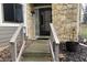 Home entryway showcasing a stone facade, black front door, and well-kept landscaping at 5746 Overcrest Dr, Indianapolis, IN 46237