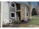 Charming townhouse features stone accents, gray siding, and well-maintained landscaping at 5746 Overcrest Dr, Indianapolis, IN 46237