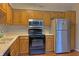 Functional kitchen featuring wood cabinetry, stainless steel appliances, and ample counter space at 5746 Overcrest Dr, Indianapolis, IN 46237