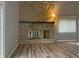 Bright living room featuring a stone fireplace, wood floors, and neutral color palette at 5746 Overcrest Dr, Indianapolis, IN 46237