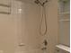Shower with tile surround and brushed nickel shower head and fixtures at 5746 Overcrest Dr, Indianapolis, IN 46237