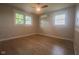 Bedroom featuring hardwood floors, two windows, and ceiling fan providing ample natural light at 7302 N Banta Rd, Bargersville, IN 46106